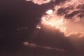 Crepuscular rays of the sun streaming through dark clouds Royalty Free Stock Photo