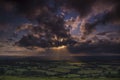 Crepuscular rays of sunlight shine onto fields in Dorset
