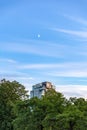 Crescent moon above the new luxury hotel - Hotel X Toronto, as sunset light hits the building