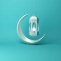 Crescent moon and arabic hanging lamp on blue pastel background studio lighting.