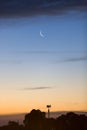 Crescent Moon On Gradient Skyscape With Mobile Cell Tower In Silhouette