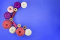 Crescent Moon Multicolored balls and bobbins of woolen yarn, sleeves of wooden thread on blue background. White, purple, pink Royalty Free Stock Photo