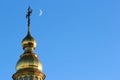 Crescent moon near the cross on top of St. Michael`s Golden-Domed Monastery in Kyiv, Ukraine