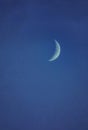 Crescent moon on the night sky seen trough clouds Royalty Free Stock Photo