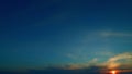 Crescent moon rising. Cloud with purple shadow in blue sky. Sun halo is visible as cirrus clouds form in the sky. Time Royalty Free Stock Photo