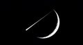 A crescent moon with a striking thin sliver of light crossing its surface. The moon Royalty Free Stock Photo