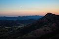 crescent moon between two hill peaks Royalty Free Stock Photo