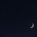 Crescent moon and Venus in dark night sky Royalty Free Stock Photo