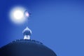 Crescent and star, symbol of Islam on dome of the mosque with blue sky