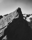 The crest of a rock against the backdrop of a mountain landscape at dawn B&W Royalty Free Stock Photo