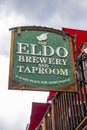 Large sign attached to wooden deck for the Eldo Brewery and Taproom-A sunny Place for Shady People