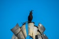 Crested eagle sitting on a wind pump