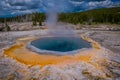 Crested pool hot spring and orange microbial mat in the old faithful geyser basin of Yellowstone National Park, Wyoming Royalty Free Stock Photo