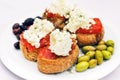 Cretan appetizer - dakos, rusk with tomato sauce, olives and local staka cheese