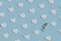 Creative romantic pattern with white wooden hearts and bottle with message. Blue pastel background. minimal concept Royalty Free Stock Photo