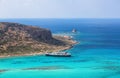 Crete coast, Balos bay, Greece. The ship is going on the marvelous turquoise sea. Popular touristic resort. Summer landscape. Royalty Free Stock Photo