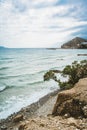 Crete, Greece. beach with rocks and cliffs with view towards sea ovean on a sunny day. Royalty Free Stock Photo