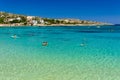 CRETE, GREECE - JULY 01 2023: Swimmers and paddleboarders in the beautiful, clear, shallow waters of Marathi, Chania, Crete