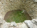 Crete, Greece - November, 2017: Pit for sacrifices, laid out with stones, the west courtyard of the Knossos palace Royalty Free Stock Photo
