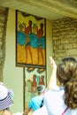 Crete  Greece -: Blurred tourists in front of a Greek paintings of Cup Bearer Fresco in the ruins of palace of Royalty Free Stock Photo