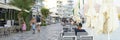 Crete / Greece - September 2019: evening promenade by the sea with cafe tables. banner.