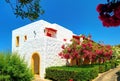 CRETE ISLAND, GREECE, JULY 01, 2011: View on Aldemar hotel villa among colorful flowers for tourists guests. Classical Greek hotel