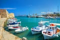 CRETE ISLAND, GREECE, SEP 12, 2012: View on beautiful classic old piscatory small sea boats ships, white yachts, Greek Heraklion s Royalty Free Stock Photo