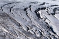 Alpine glacier crevasses exposed on surface in summer