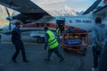 Crew of airline manage bags and passengers with police at Lukla airport Royalty Free Stock Photo