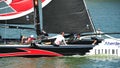 Crew of Alinghi team steering boat at Extreme Sailing Series Singapore 2013