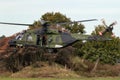 Crew chief hanging out of a German Army NH90 helicopter taking off from Deelen airbase during Falcon Autumn exercise. Deelen, The