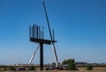 A crew erecting a business sign