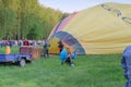 Crew inflate hot air balloon in forest meadow in Ukraine, Europe Royalty Free Stock Photo