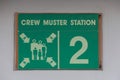 Crew muster station sign on a cruise ship open deck