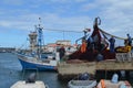 The crew of a purse seiner collects its nets in Olhao fishing harbour, Algarve, Southern Portugal