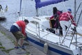 Crew of sailing yacht yachtsmen moor to a berth using ropes