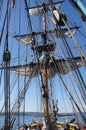 Crew unfurls a sail on a yardarm