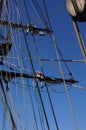 Crew unfurls a sail on a yardarm