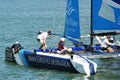 Crew of Wave Muscat steering boat at Extreme Sailing Series Singapore 2013