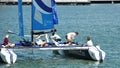 Crew of Wave Muscat steering boat at Extreme Sailing Series Singapore 2013