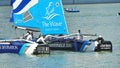 Crew of The Wave Muscat steering boat at Extreme Sailing Series Singapore 2013