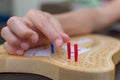 Cribbage card game and board up close looking at the blue and red pegs