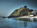 Beautiful ancient castle ruins overlooking the sea, intriguing coloring, artistic style art Royalty Free Stock Photo