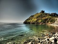 Beautiful ancient castle ruins overlooking the sea, intriguing coloring, artistic style art Royalty Free Stock Photo