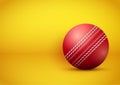 Cricket ball on bright orange background Royalty Free Stock Photo