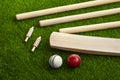 Cricket bat ball stumps and bails placed on green grass cricket pitch background Royalty Free Stock Photo