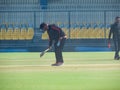 Cricket groundsman sweeping away dirt from pitch. Royalty Free Stock Photo