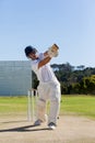 Cricket player batting on field against sky