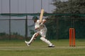 Cricket school boy is attacking the ball Royalty Free Stock Photo