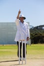 Cricket umpire signalling out during match